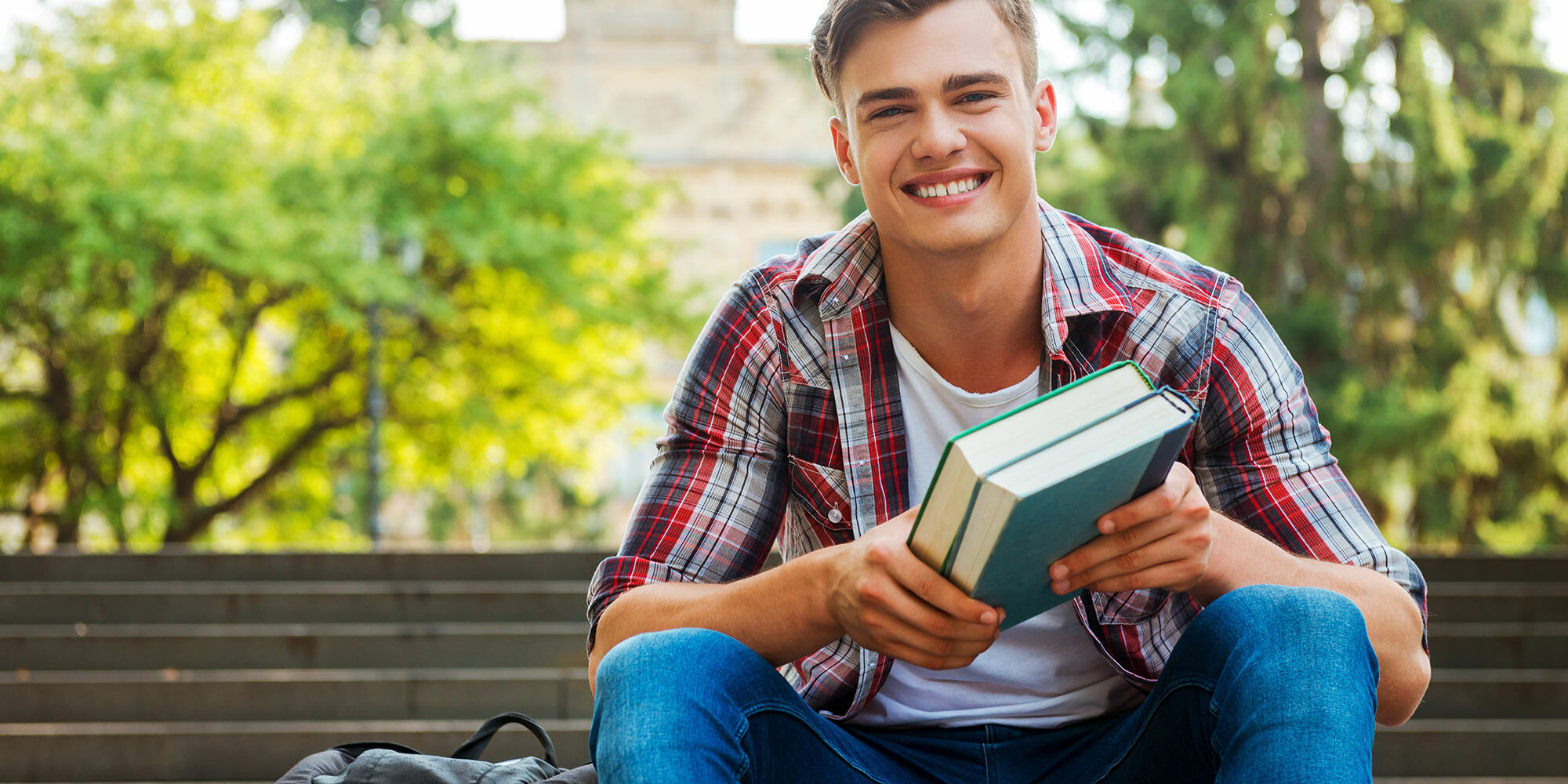 male student sitting on staircase